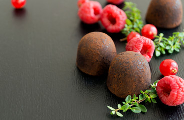 Chocolate truffles on a grey background.