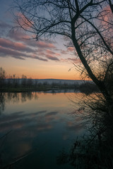 Colorful sky with reflections in the water of the river Mures, Romania
