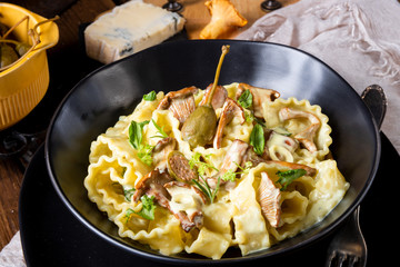 Reginette noodles in cream sauce with fresh chanterelles and capers