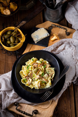 Reginette noodles in cream sauce with fresh chanterelles and capers