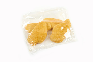 fried chicken breast in a transparent packageon white background.