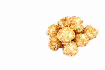 Pile of caramel popcorn on white background.