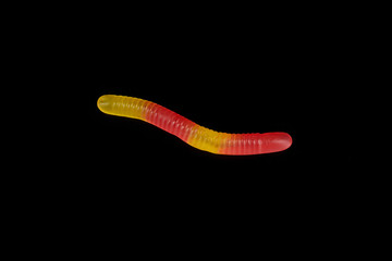 gummy jelly worm candy on a black background.