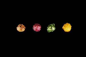 multicolored caramel popcorn on a black background.