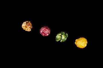 multicolored caramel popcorn on a black background.