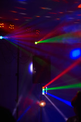 Stage lights in action at the concert. Lights show. Lazer show. Night club dj party people enjoy of...