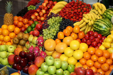 Fototapeta na wymiar Farmers market with various colorful fresh healthy fruits for sale. A big choice of ripe various fresh fruits on market
