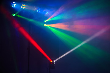 Stage lights in action at the concert. Lights show. Lazer show. Night club dj party people enjoy of music dancing sound with colorful light. club night light dj party club. Smoke Machine and lights