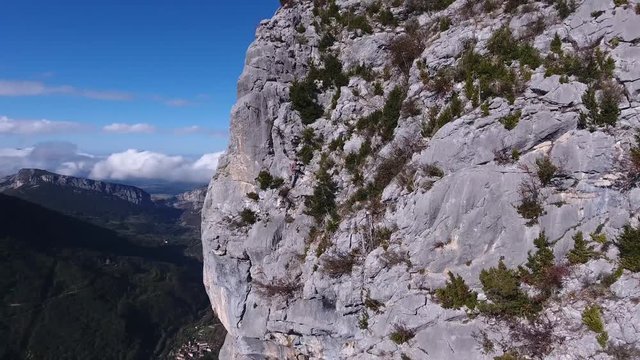 Drone selfie of a man on the edge of a cliff in Vercors mountains. France