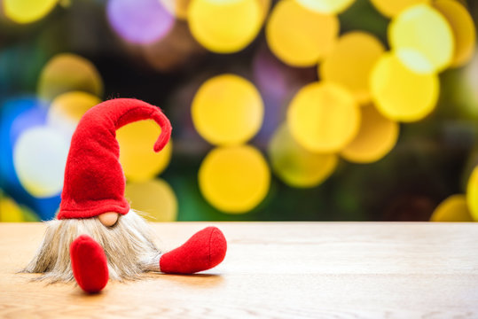 Red christmas dwarf for holidays with bokeh lights in background