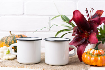 Two white campfire enamel mug mockup with pumpkin and lily