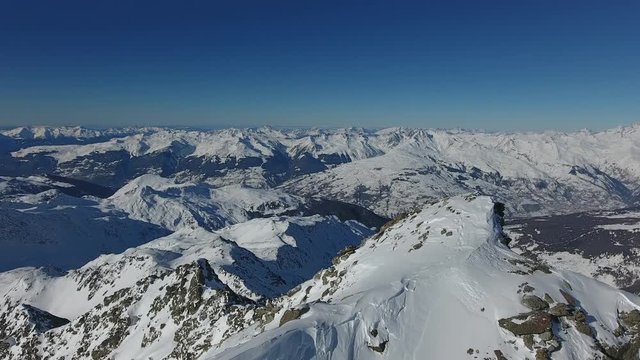 Flying along  the ridge of the mountain in the french alps. Aerial shot sunny day