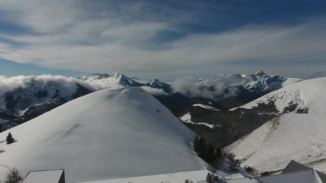 Flying over the sanctuary and church la salette in France. Snowy landscape sunny day. 