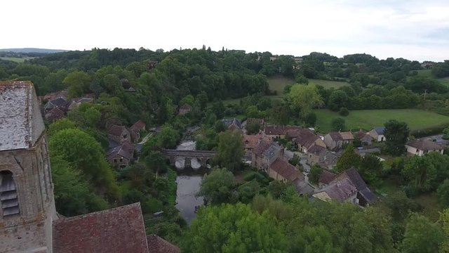 Drone shot flying over the village Saint-Ceneri-le-Gerei low altitude flight. Cloudy day. Location France 