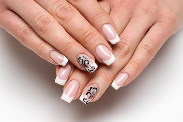 classic white French manicure with black monograms and crystals on long square nails on a white background close-up
