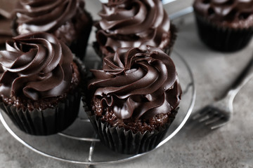 Tasty chocolate cupcakes on grey table, closeup