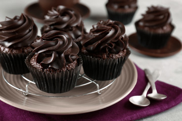 Tasty chocolate cupcakes on grey table, closeup
