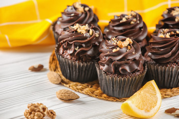 Delicious chocolate cupcakes on wooden table