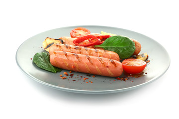 Plate with delicious grilled sausages and vegetables on white background