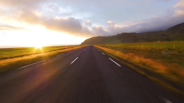 Normal speed driving in Iceland. Road view during sunset.