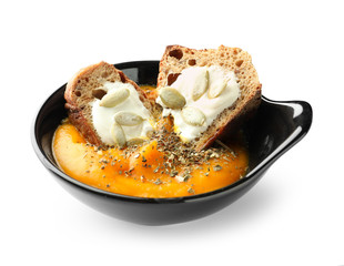 Bowl with tasty pumpkin cream soup on white background
