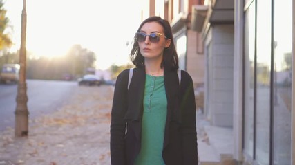Young woman visually impaired with a cane walking around the city