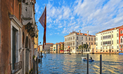 glimpse of Venice with Canal Grande with gondola boats, historic colorful facade buildings, windows...