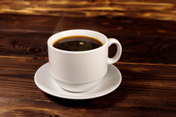 Cup of coffee on the wooden table