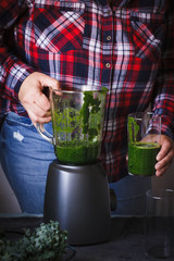 Green smoothies. Woman plus size serve green smoothie detox, drink weight loss keto food.