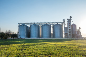 silver silos on agro-processing plant for processing and storage of agricultural products, flour, cereals and grain © hiv360