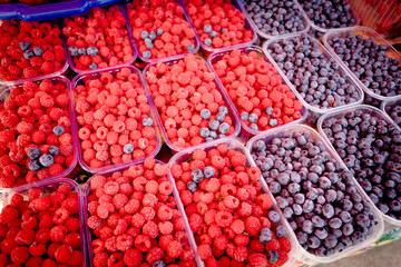 Berry fruits in baskets at a marketplace. mixed berries at eco market