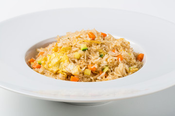 Rice sautéed with vegetables and egg on white background