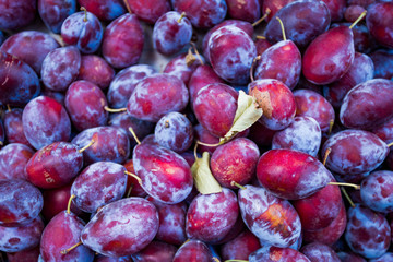 Ripe juicy plums as background