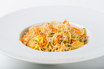 Grilled soy spaghetti with vegetables and egg on white background