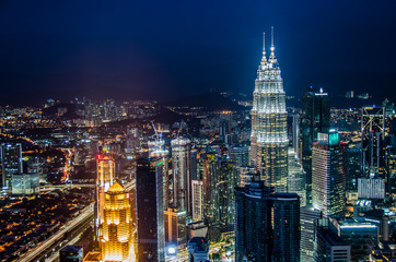 Naklejka na ściany i meble Famous Petronas Twin Towers skyscrapers Kuala Lumpur, Malaysia. Aerial skyline view at night