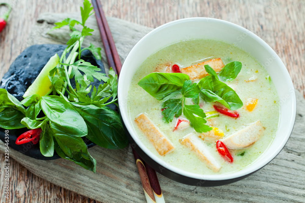 Sticker vegan thai green curry with fried firm tofu pieces, sesonal vegetable, red bird's eye chili and swee