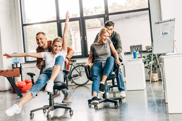 group of young business people riding chairs at modern office