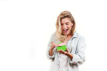 a very beautiful young emotional girl rejoices at the received gift and screams with happiness on a white isolated background