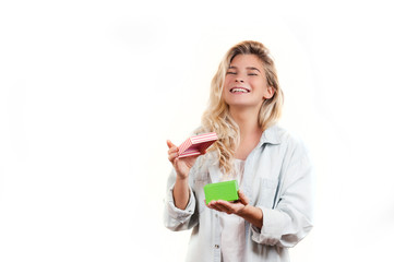 a very beautiful young emotional girl rejoices at the received gift and screams with happiness on a white isolated background