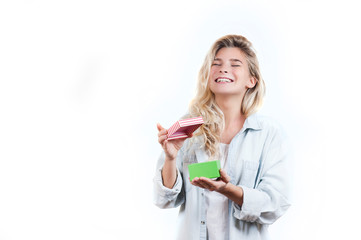 a very beautiful young emotional girl rejoices at the received gift and screams with happiness on a white isolated background