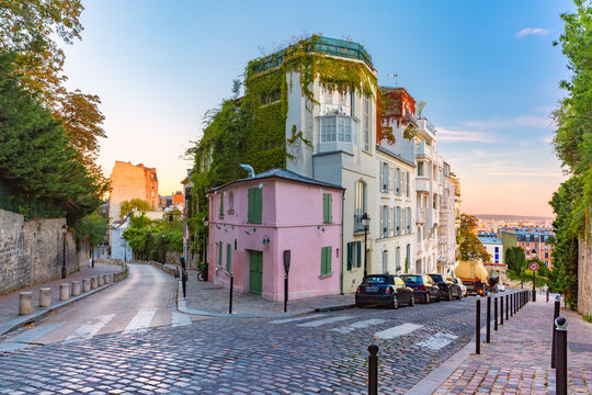 Fototapeta Cozy old street with pink house at the sunny sunrise, quarter Montmartre in Paris, France