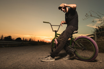 Portrait of a young man with a bmx bicycle