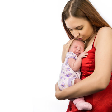 Pretty woman holding a newborn baby in her arms. Copy space, free space for your text