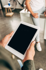 cropped shot of man holding tablet with blank screen at office