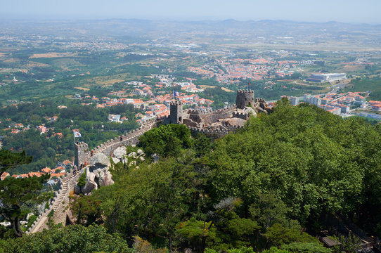 View of Castle of the Moors on the top of the mountain over the Sintra town. Sintra. Portugal