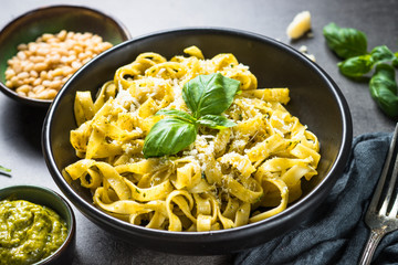 Tagliatelle pasta with pesto sauce and parmesan.