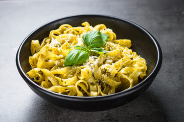 Tagliatelle pasta with pesto sauce and parmesan.