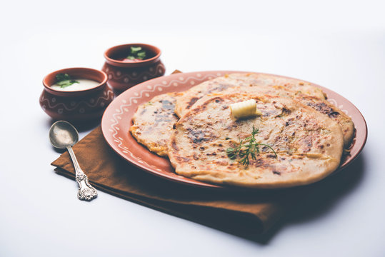Aloo Paratha / Indian Potato stuffed Flatbread. Served with fresh curd and tomato ketchup. selective focus