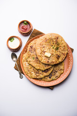 Aloo Paratha / Indian Potato stuffed Flatbread. Served with fresh curd and tomato ketchup. selective focus