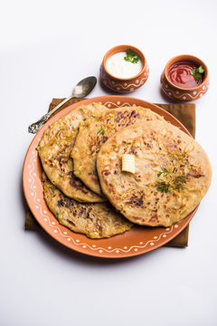 Aloo Paratha / Indian Potato stuffed Flatbread. Served with fresh curd and tomato ketchup. selective focus